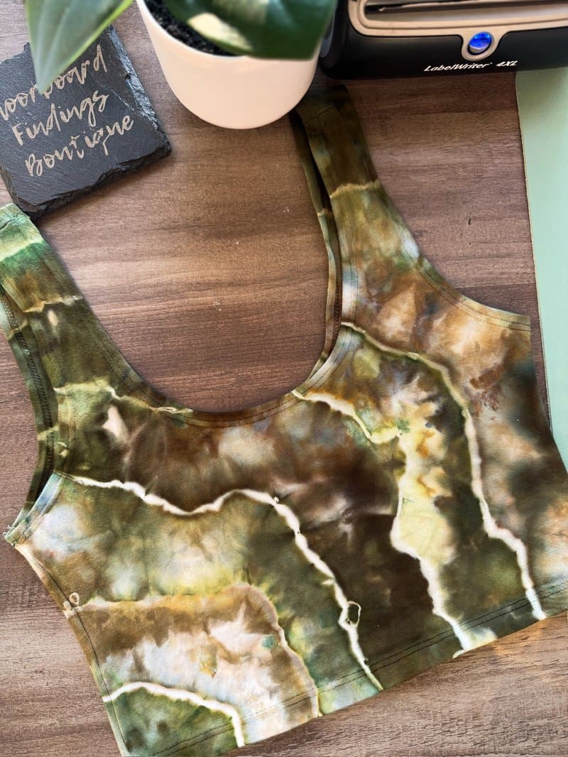 Earth tone ice-dyed crop top flatlay with branded Floorboard Findings sign