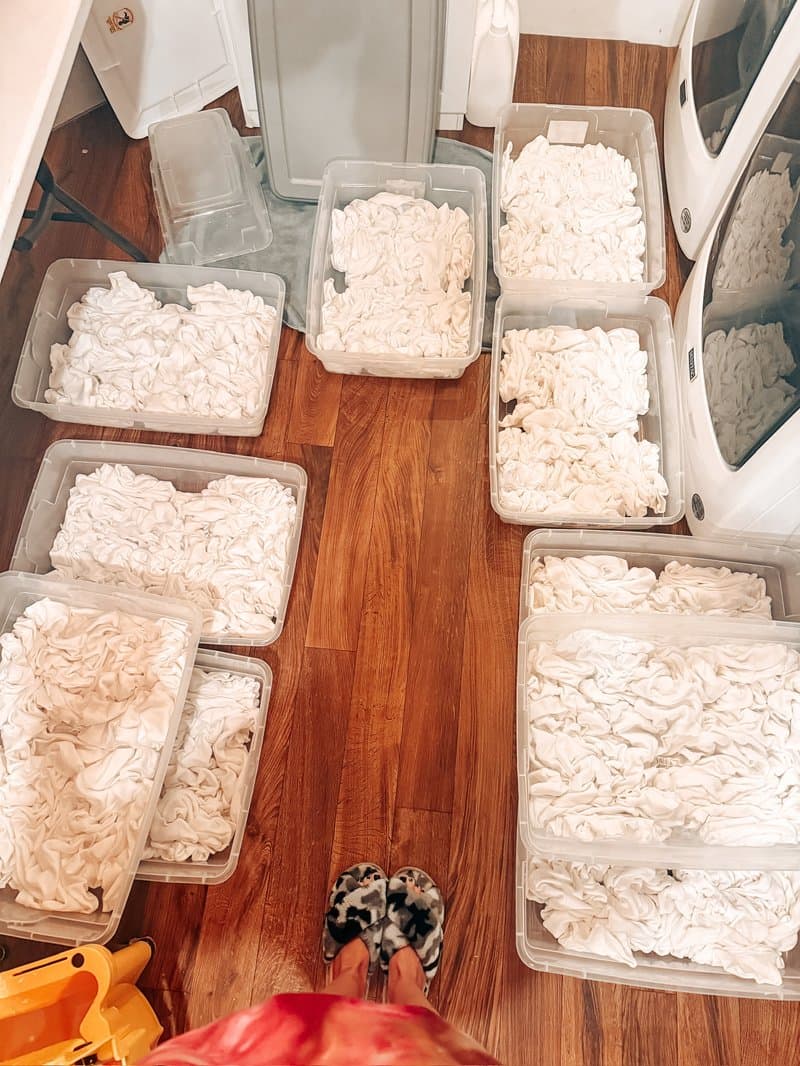 Overhead view of bins filled with white blanks soaking in soda ash